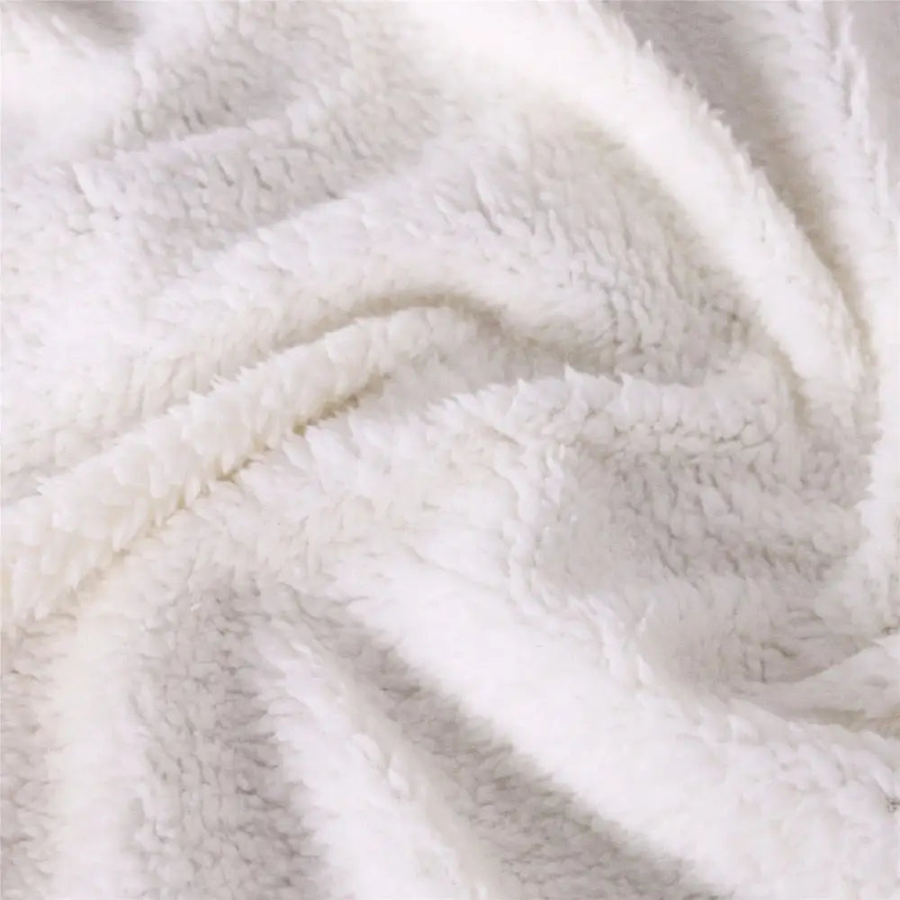 Soft white fluffy fleece fabric showcasing gentle folds and texture of Golden Lotus Blanket