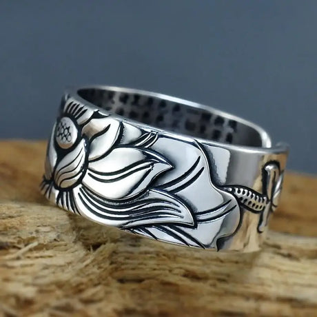 Silver ring featuring an engraved lotus flower design for good luck in sterling silver