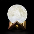 Glowing GoodNight Moon Lamp night light on a wooden stand for cozy ambiance