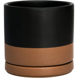 Two-toned ceramic planter pot with drainage hole featuring a matte black top and terracotta bottom