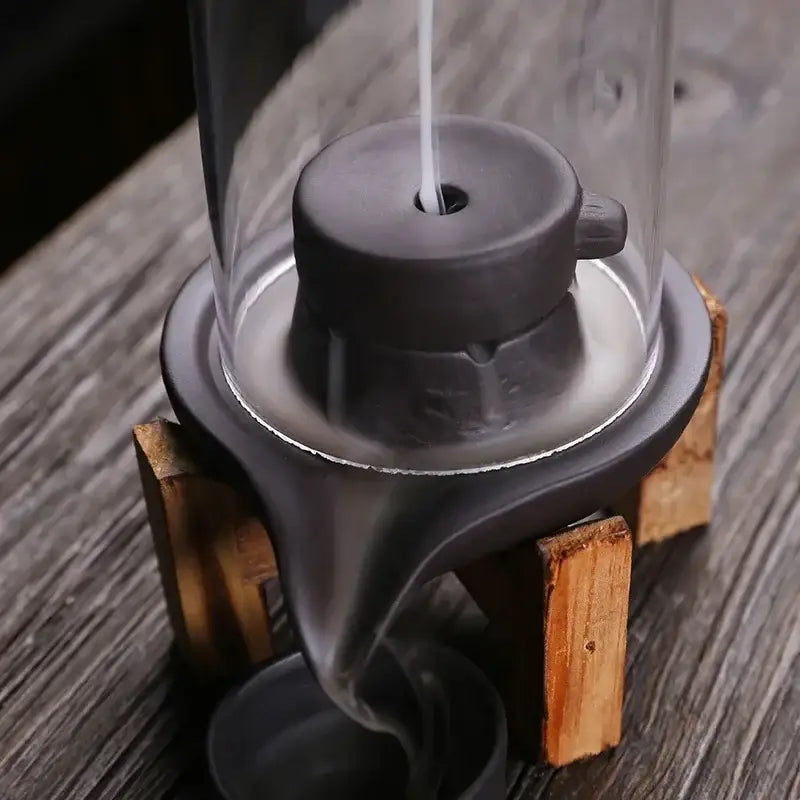 Handmade ceramic incense burner creating a cascading smoke waterfall effect