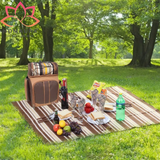 Picnic setup featuring Hap Tim Picnic Backpack cooler with blanket and food spread