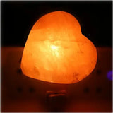 Heart-shaped Himalayan salt lamp emitting warm white glow for cozy ambiance