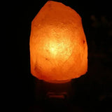 Glowing Himalayan salt lamp emitting warm white light for a cozy ambiance