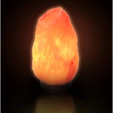 Glowing Pink Himalayan Salt Lamp emitting warm orange light for natural ambiance