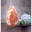 Pink Himalayan salt lamp glowing warmly, enhancing ambiance with natural salt benefits