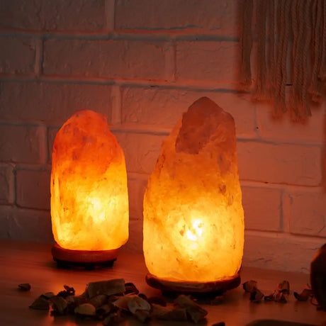 Two glowing Himalayan Salt Lamps emitting warm orange light from Natural Salt