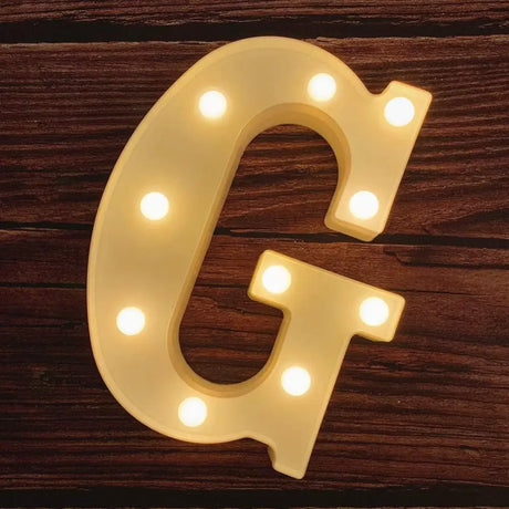 Illuminated marquee letter G in glowing lights for Happy Birthday sign display