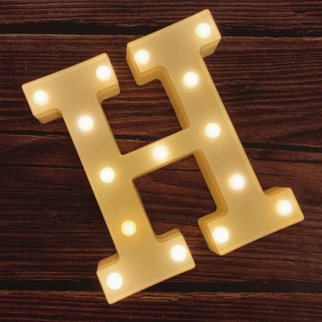 Illuminated marquee letter H with glowing bulbs for Happy Birthday Sign decoration