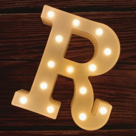 Illuminated marquee letter R with glowing bulbs for a Happy Birthday sign