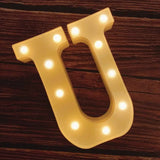 Illuminated marquee letter U with glowing LED bulbs for birthday celebrations