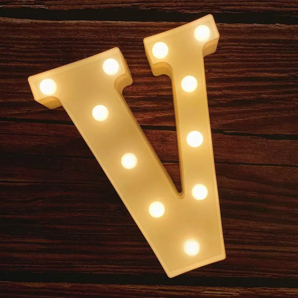 Illuminated marquee letter V with glowing bulbs in Happy Birthday Sign display