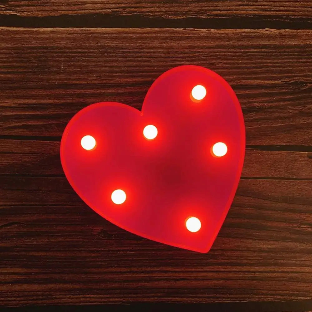 Red heart-shaped light fixture with bulbs for illuminated marquee letters birthday sign