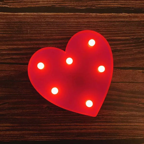 Red heart-shaped light fixture with bulbs for illuminated marquee letters birthday sign