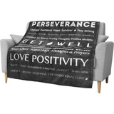 Inspirational sofa with Healing Fleece Blanket featuring uplifting words for comfort