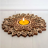 Wooden mandala design candle holder with intricate patterns and a lit yellow candle