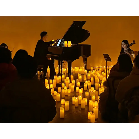 Grand piano illuminated by LED flameless candles with real flame effect during performance