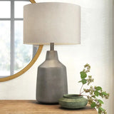 Gray Lockwood Concrete Table Lamp with a white drum shade for modern decor