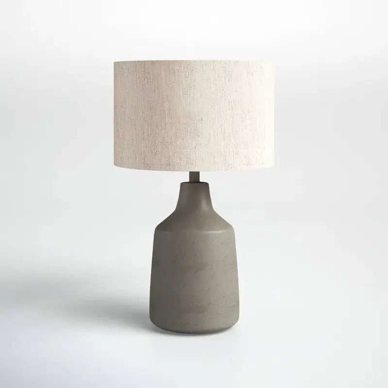 Gray ceramic Lockwood Concrete Table Lamp with a beige drum shade for stylish lighting