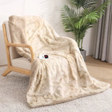 Cream-colored soft faux fur throw blanket draped over a wooden armchair