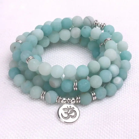 Beaded mala beads bracelet with frosted aqua stones, silver spacers, and Om charm pendant