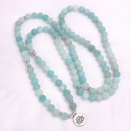 Matte aqua blue mala beads necklace with silver spacers and lotus charm pendant