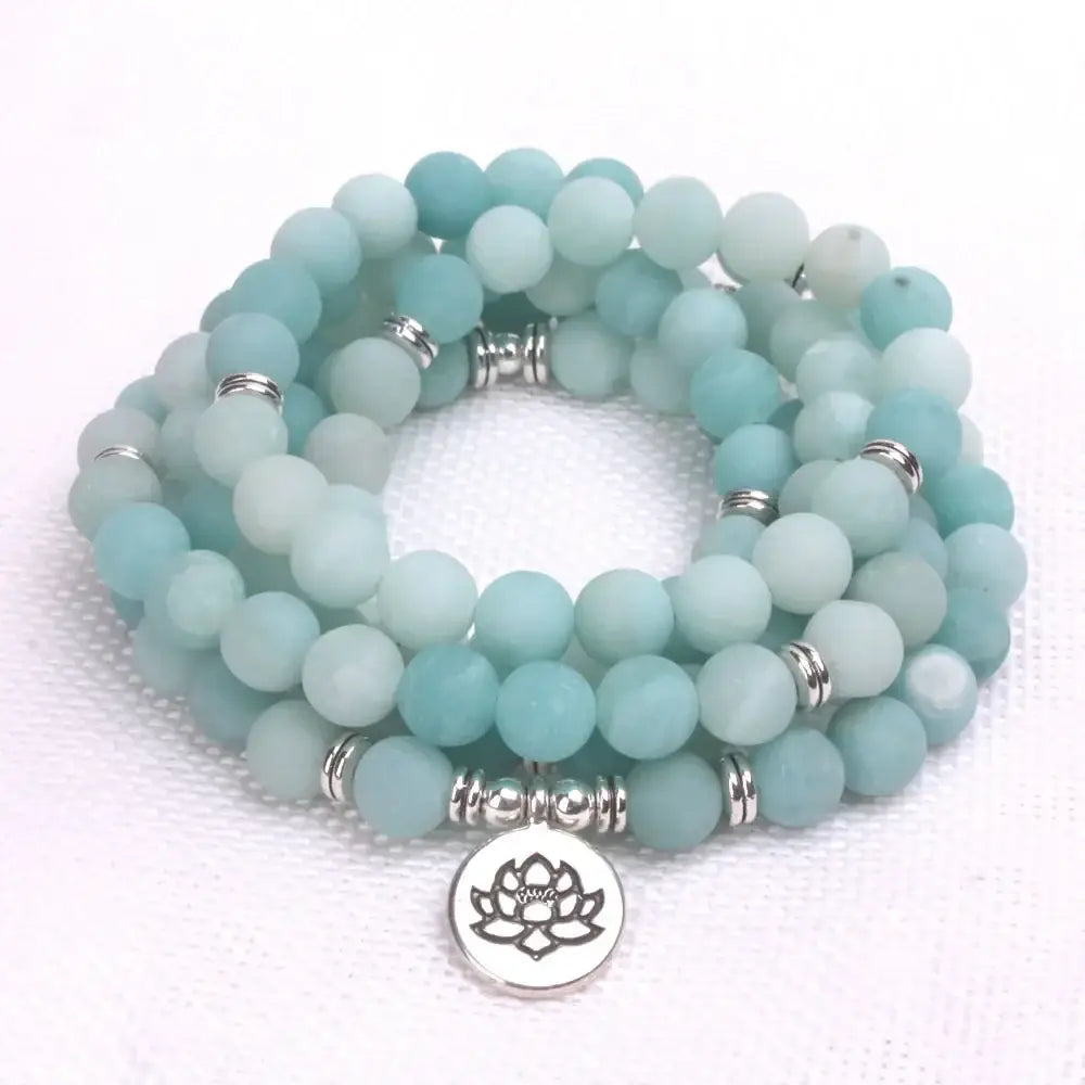 Beaded mala beads bracelet with frosted aqua stones and a lotus charm pendant