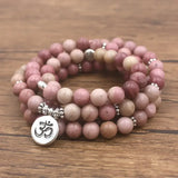 Pink Rhodonite mala beads bracelet with silver Om charm for spiritual jewelry enthusiasts