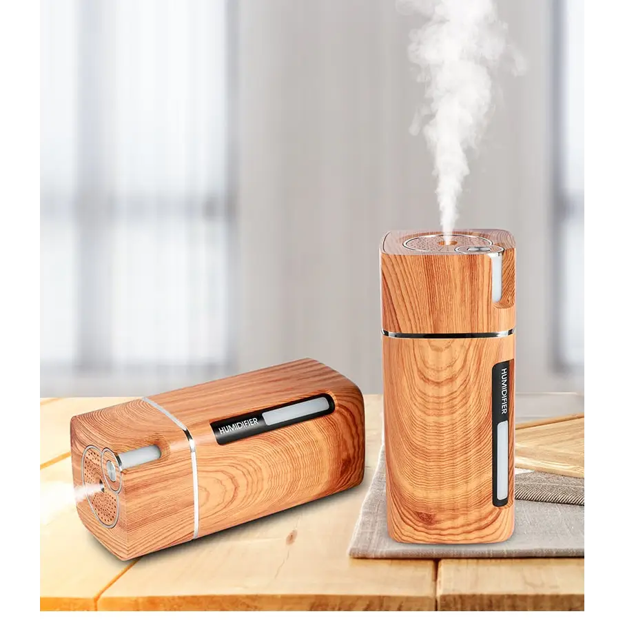 Wooden-textured oil diffuser emitting steam with LED night light for aromatherapy