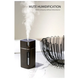 Black cylindrical oil diffuser emitting mist with LED night light feature