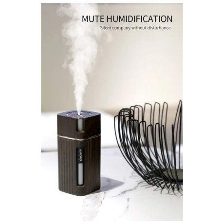 Black cylindrical oil diffuser emitting mist with LED night light feature