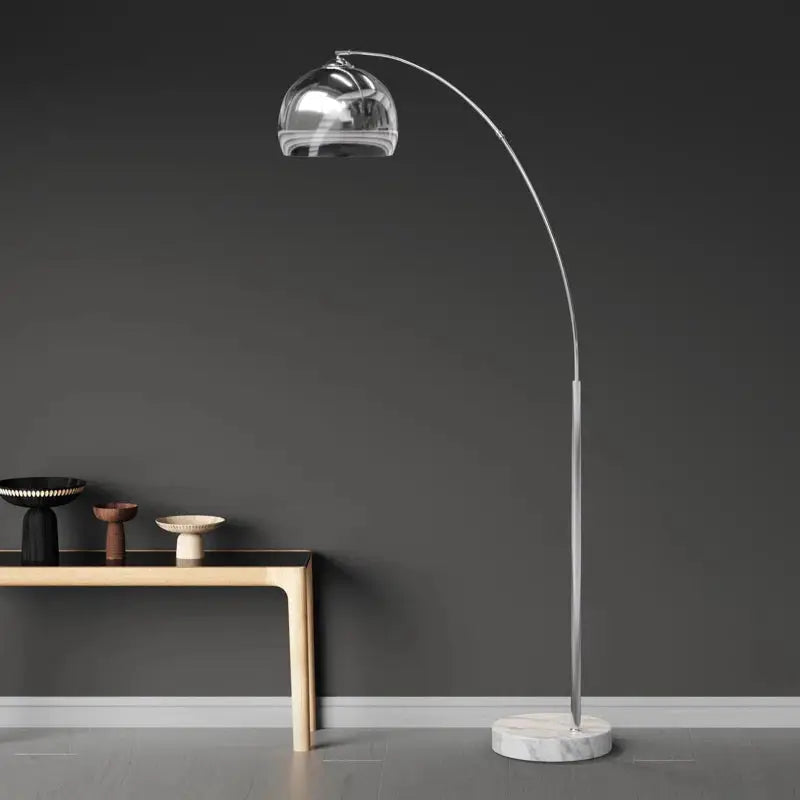 Chrome arc floor lamp with marble base and dome-shaped metallic shade for stylish décor