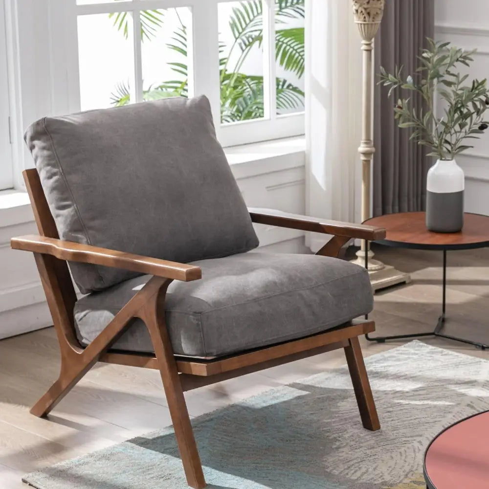 Mid-century modern brown leather accent chair with removable cushions and wooden frame