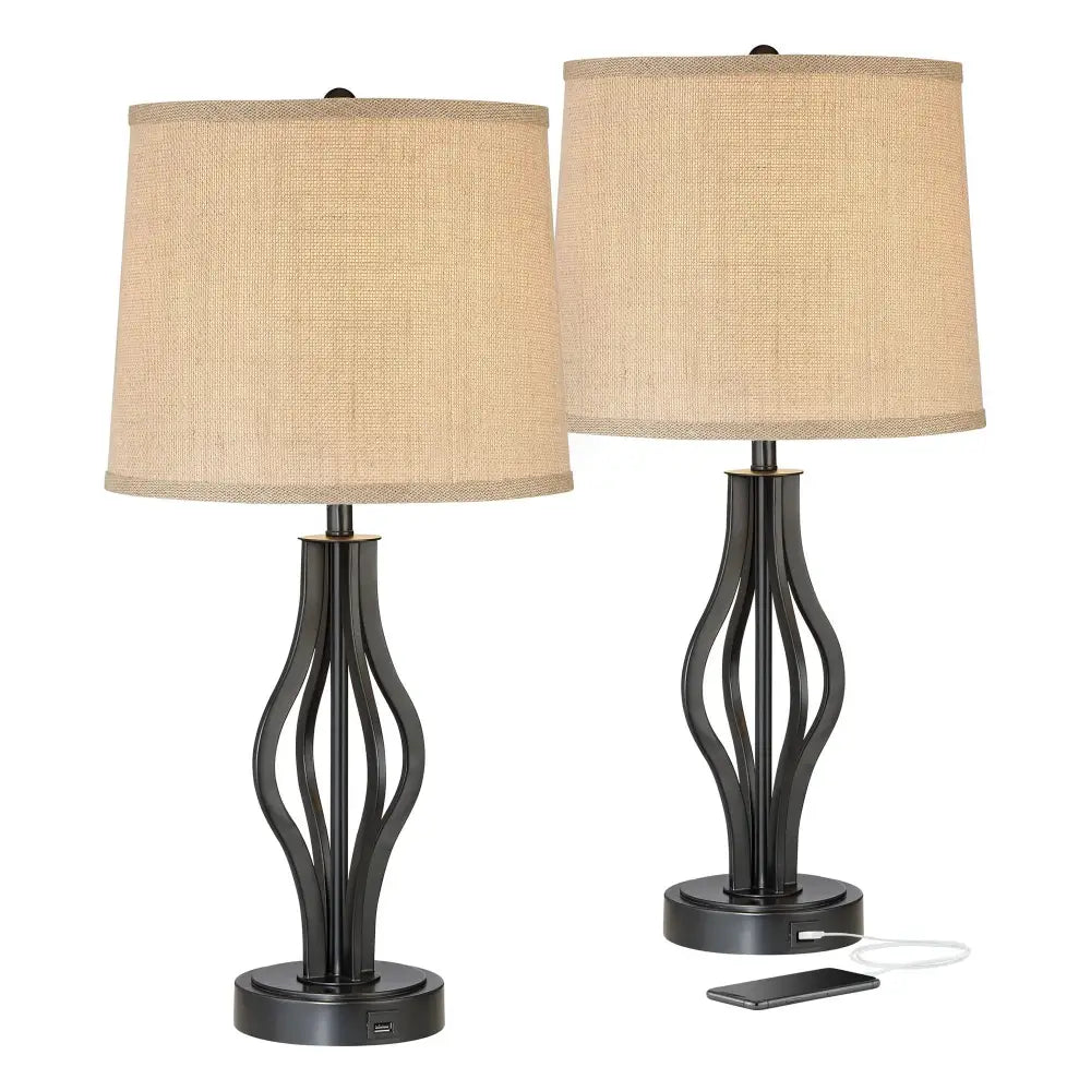 Two dark iron modern industrial table lamps with beige drum shades and USB charging