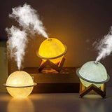 Three Moon Lamp Humidifiers with wooden stands emitting soothing steam and LED light