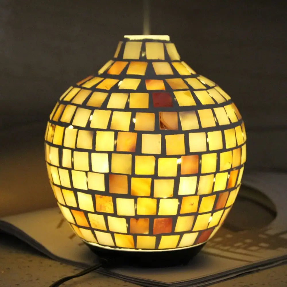 Glowing mosaic design aroma diffuser with yellow and amber tiled spherical shape