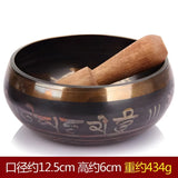 Tibetan singing bowl with wooden striker and carved Sanskrit symbols, Himalayan hand-hammered