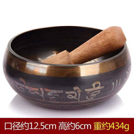 Tibetan singing bowl with wooden striker and carved Sanskrit symbols, Himalayan hand-hammered