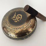 Decorative metal singing bowl with Arabic calligraphy and ornate patterns, Himalayan hand-hammered