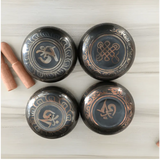 Four Tibetan bowls featuring decorative symbols in a Himalayan hand-hammered finish