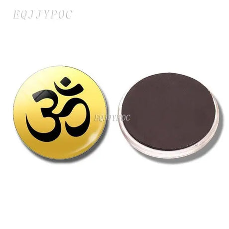 Circular magnet with Om symbol in black on golden yellow for boho refrigerator decor