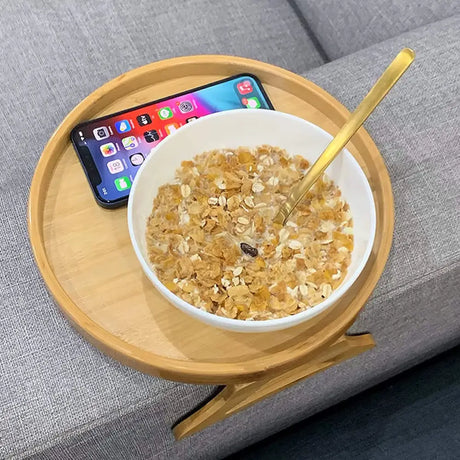 Bowl of oatmeal with nuts on Portable Round Pine Wood Sofa Tray next to an iPhone