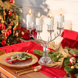 Silver candelabra with four lit white candles in a Reindeer Candle Holder decor