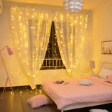 String lights draped over sheer white curtains create a glowing effect for romantic decor