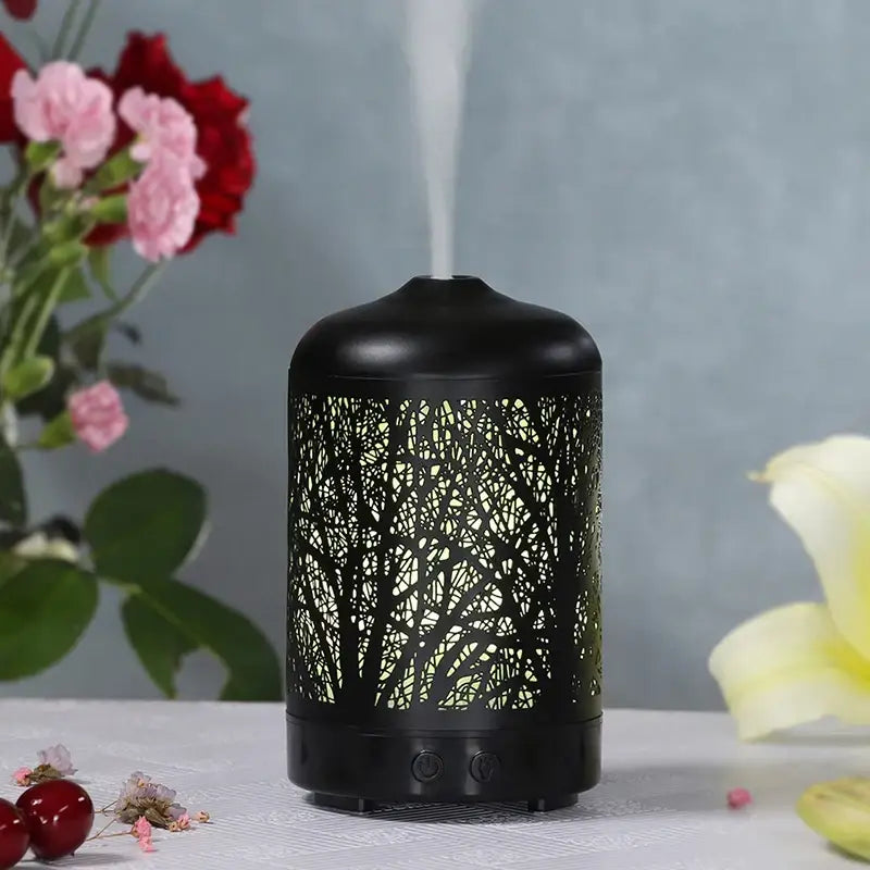 Black metal essential oil diffuser with forest tree design for ultrasonic aromatherapy