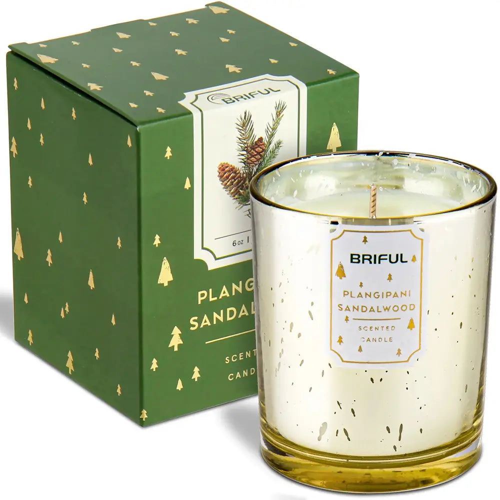 Decorative scented soy candle in gold-rimmed glass with matching green gift box