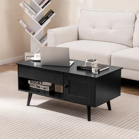 Modern black coffee table with hidden storage compartment and angled legs for sleek decor