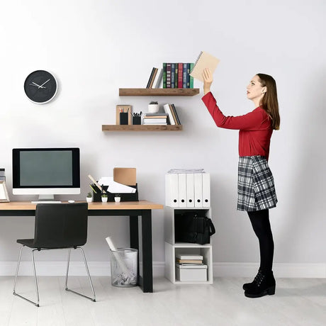 Person in a red sweater and plaid skirt reaching for Stylish Mahogany Floating Shelves in living room