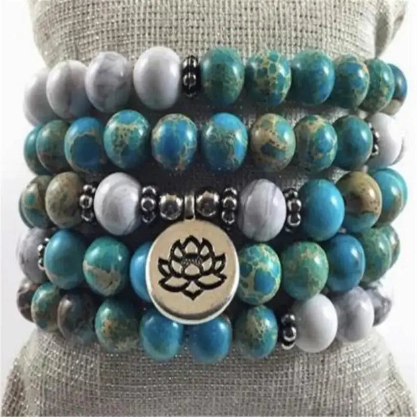 Stacked turquoise and gray beaded bracelets with a lotus charm in a Mala Beads Bracelet