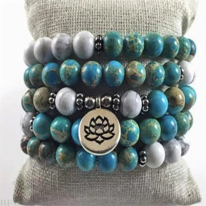 Stacked turquoise and gray beaded bracelet with lotus charm in a Mala Beads style